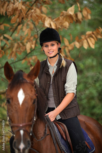 Photo: Young girl riding a horse Young girl riding a horse