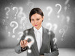 Business woman with question symbols around her. Choosing one an