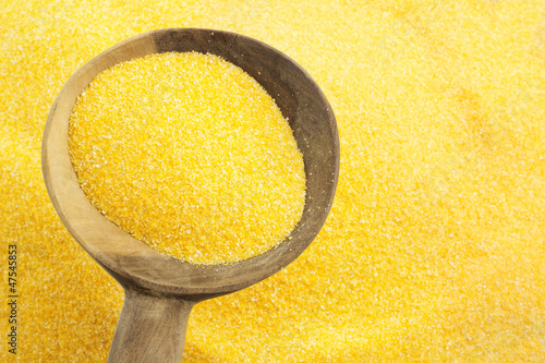 Photo: maize flour and wooden spoon maize flour and wooden spoon