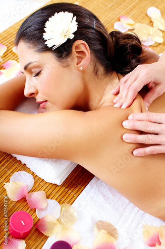 Photo: Young woman getting massage in spa salon. Young woman getting massage in spa salon.