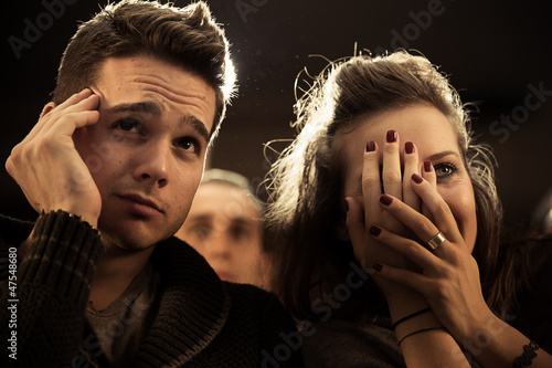 Photo: Couple scared at the cinema, watching horror movie Couple scared at the cinema, watching horror movie