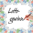 Hand mit Stift schreibt das Wort Lottogewinn