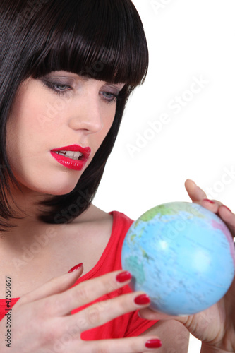 Photo: Woman searching on a globe Woman searching on a globe