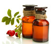 medicine bottles with hip roses, isolated on white