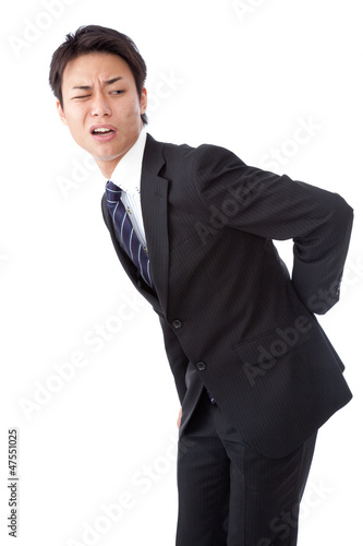 Photo: businessman suffering from low back pain businessman suffering from low back pain