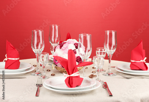 Photo: Table setting in red tones on color background Table setting in red tones on color background
