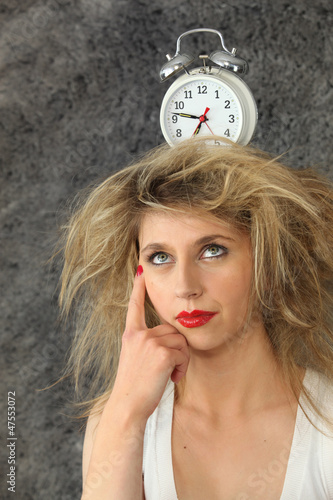 Photo: young woman with a clock on her head young woman with a clock on her head