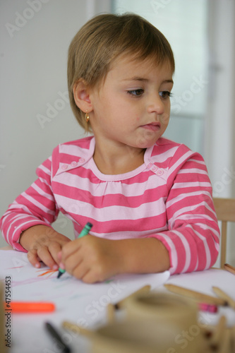 Photo: Little girl coloring in Little girl coloring in