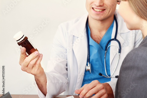 Photo: Male doctor and young woman patient Male doctor and young woman patient