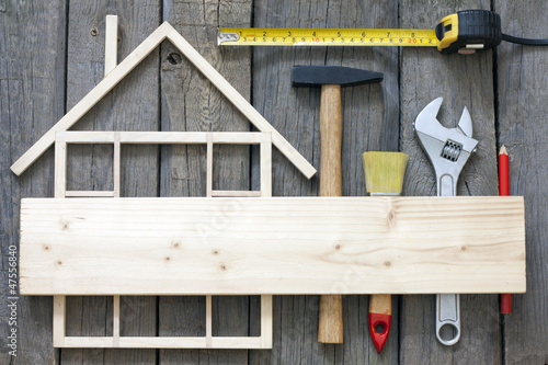 Photo: Wooden home construction renovation and tools background Wooden home construction renovation and tools background