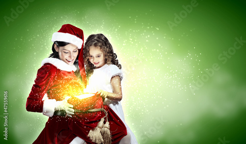 Photo: Little girl with christmas gifts and santa Little girl with christmas gifts and santa