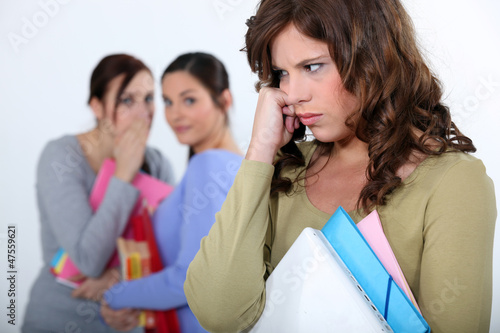 Photo: Girls criticizing another girl Girls criticizing another girl