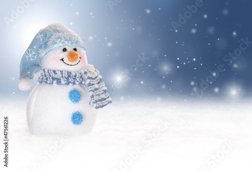 Photo: Winter background with a snowman, snow and snowflakes Winter background with a snowman, snow and snowflakes
