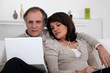 Mature couple sitting with computer