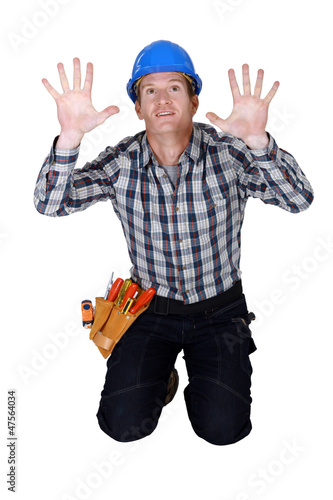 Photo: Tradesman pressing his hands against a see-through wall Tradesman pressing his hands against a see-through wall