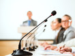 microphone stand in the row in front of businessmen