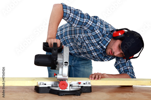 Photo: Man using circular saw Man using circular saw