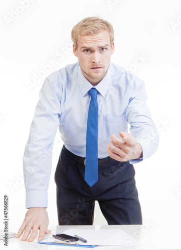 Photo: angry boss behind desk angry boss behind desk