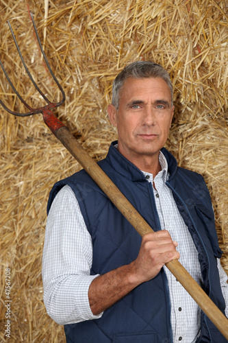 Photo: Farmer holding a pitchfork Farmer holding a pitchfork