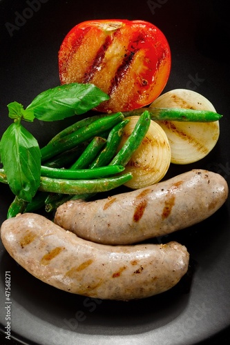 Photo: Sausages and fried tomatoes. Sausages and fried tomatoes.