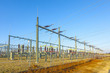 high voltage tower in rural landscape with blue sky