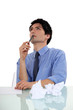 businessman writing and thinking