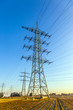 hight voltage tower in rural landscape with blue sky