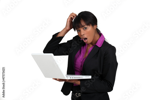 Photo: Shocked woman holding laptop Shocked woman holding laptop
