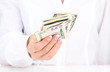 American dollars in a women hands, close up