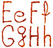 Alphabet letters made from tomato, ketchup syrup