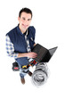 Photo: Electrician with a blank screened laptop Electrician with a blank screened laptop