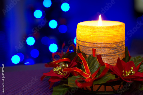 Photo: Christmas candles with blurry lights on background Christmas candles with blurry lights on background
