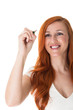 Beautiful redhead writing on a virtual screen