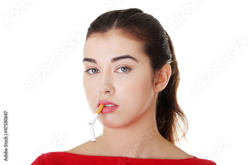 Photo: Young woman with broken cigarette. Young woman with broken cigarette.