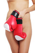 Nude woman body with boxing gloves.
