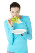 Fit young beautiful woman eating salat