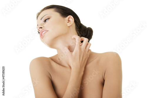 Photo: Young beautiful woman scraching her self. Young beautiful woman scraching her self.