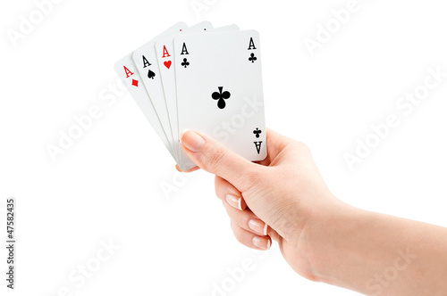 Photo: Four of a kind, woman hand holding four aces on white background Four of a kind, woman hand holding four aces on white background