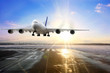 Passenger airplane landing on runway in airport. Evening