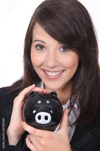 Photo: Brunette woman with piggy bank Brunette woman with piggy bank