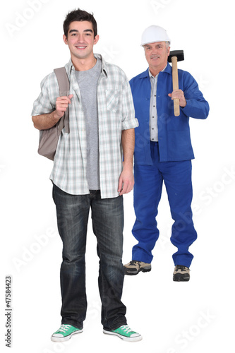 Photo: Young apprentice standing near his boss Young apprentice standing near his boss