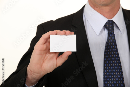 Photo: Businessman holding card Businessman holding card