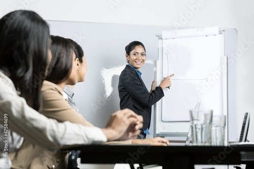 Photo: business woman drawing chart at meeting business woman drawing chart at meeting