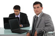 Confident worker sitting at his desk