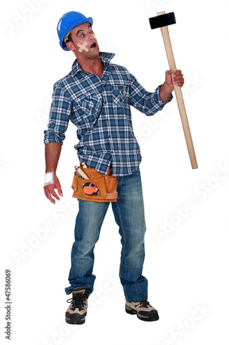 Photo: Injured workman with mallet in hand Injured workman with mallet in hand