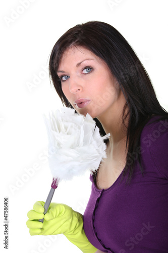Photo: Housewife blowing on her duster Housewife blowing on her duster