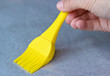 Applying oil to baking parchment with silicone pastry brush