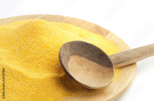 Photo: polenta on wooden plate and spoon polenta on wooden plate and spoon