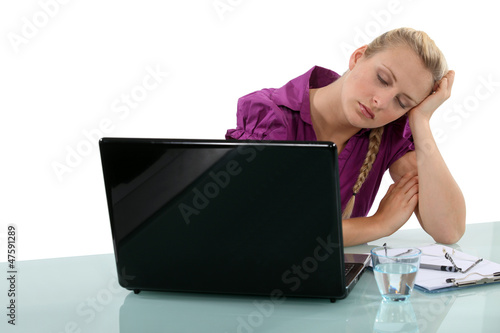 Photo: Employee falling asleep at her desk Employee falling asleep at her desk