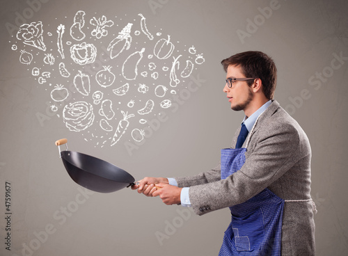 Photo: Attractive man cooking vegetables Attractive man cooking vegetables